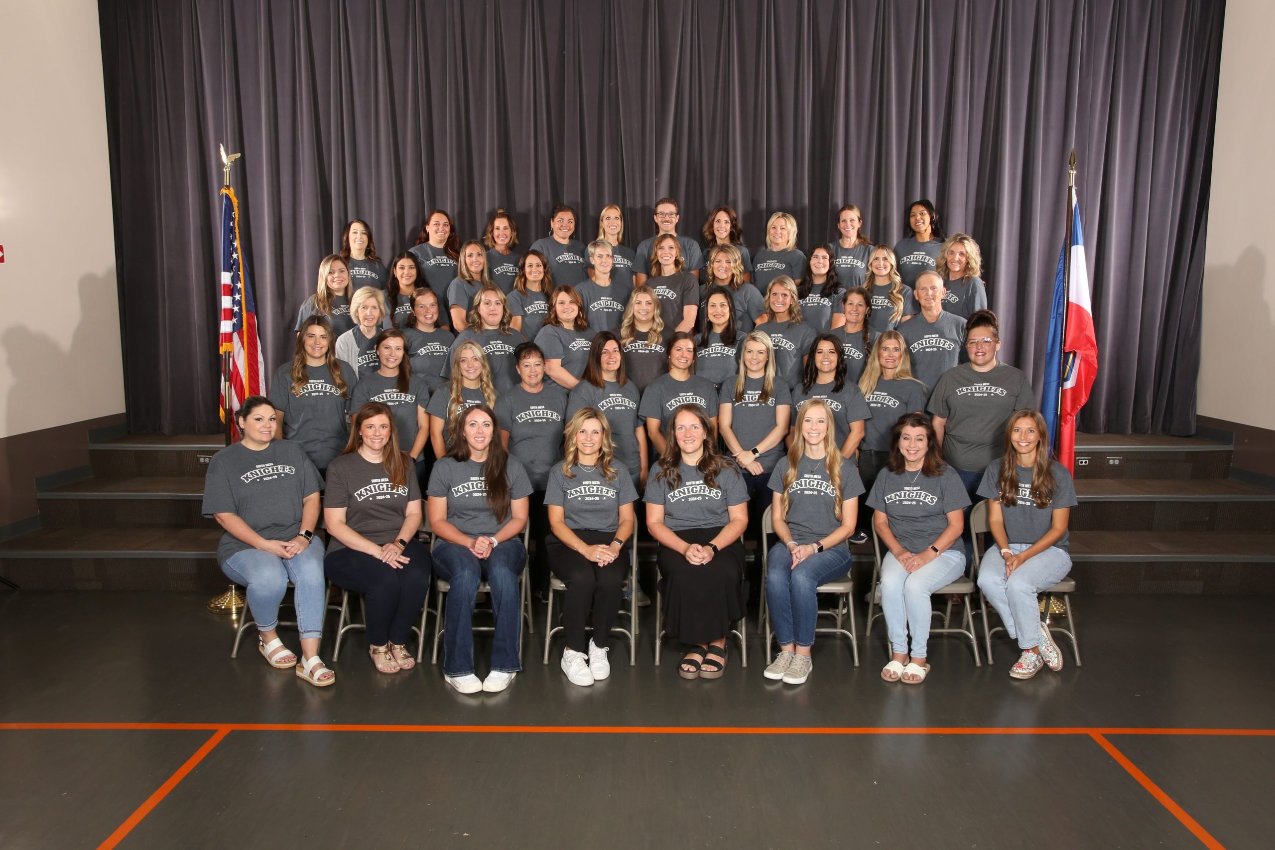 Staff member sitting and standing for a group picture